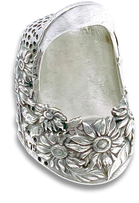 Threaded Tales: The Beauty of Handmade Thimbles, featuring a sterling silver thimble with floral designs.