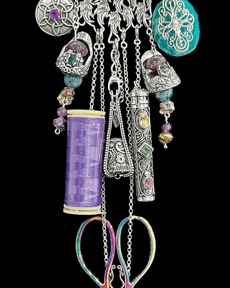 Peacock Collection featuring antique-style thimbles, sewing tools, and accessories in a stunning silver necklace.