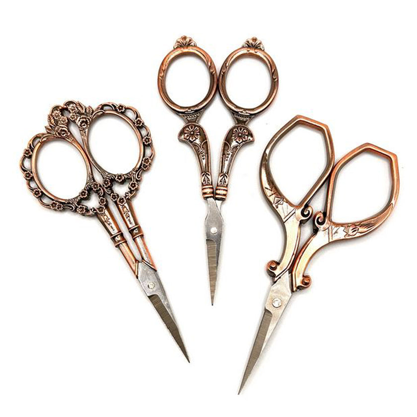 Copper Handle Scissors in three styles with intricate designs, perfect for crafting and sewing projects.