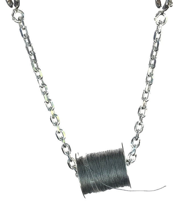 Thread Bobbin in Sterling Silver with dark thread, ideal for thimble collections and sewing accessories.