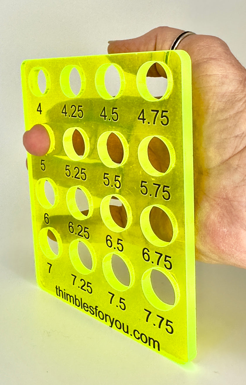 Acrylic Ring Sizer held in hand with size measurements displayed on a bright yellow background.