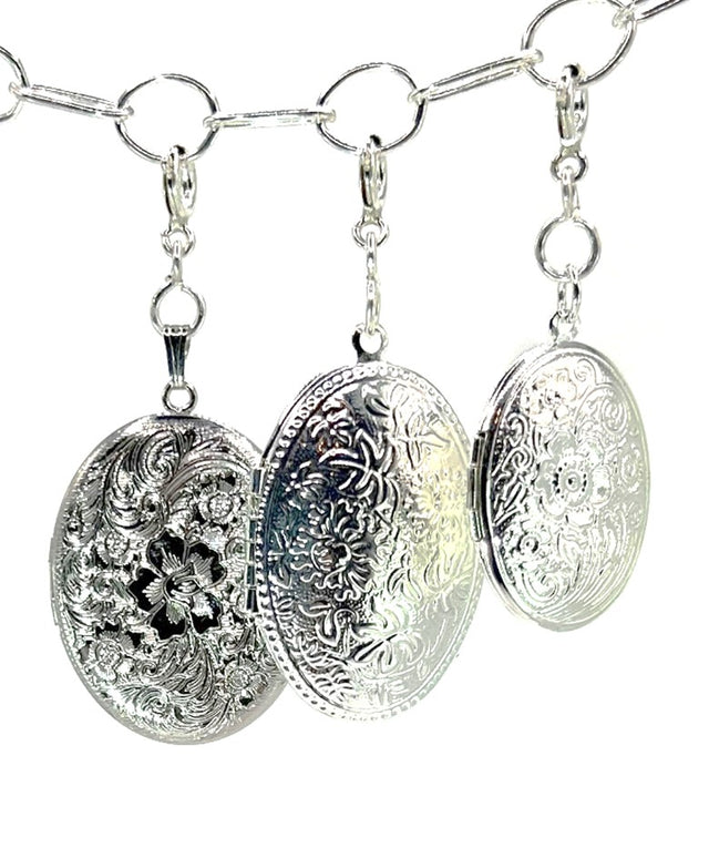 Decorative silver thimbles with intricate floral designs, perfect for sewing enthusiasts and collectors.