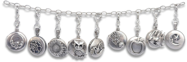 Round Beeswax Locket with intricate silver charms featuring various motifs on a decorative chain.