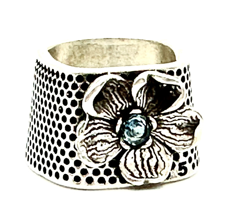 Flower Tailor's Thimble featuring a flower design and gemstone center, perfect for quilting and sewing.
