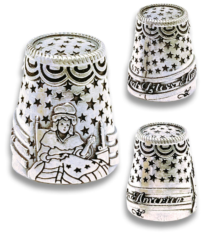 Betsy Ross Thimble in sterling silver featuring sewing artwork and 'God Bless America' inscription, collectible thimble.