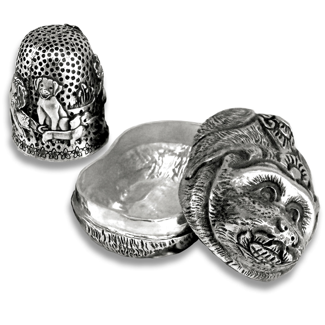 Thimble Box - Dog Small made of sterling silver, featuring intricate designs of dogs and a closed-top structure.