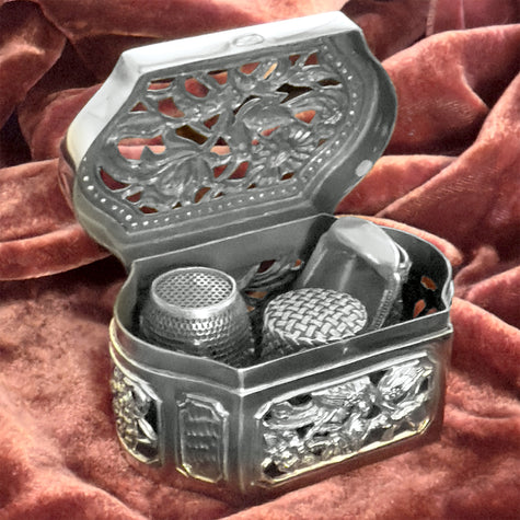 Thimble Box - Cutout featuring ornate sterling silver design and multiple thimbles, perfect for thimble collections and sewing accessories.