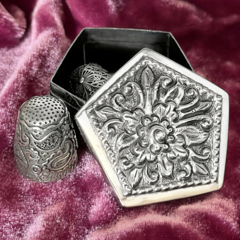 Thimble Box - Pentagon with ornate lid, showcasing artisan craftsmanship and sterling silver thimbles on display.