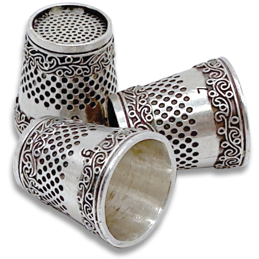 Art Thimble featuring three handmade sterling silver thimbles with intricate designs and perforated tops.