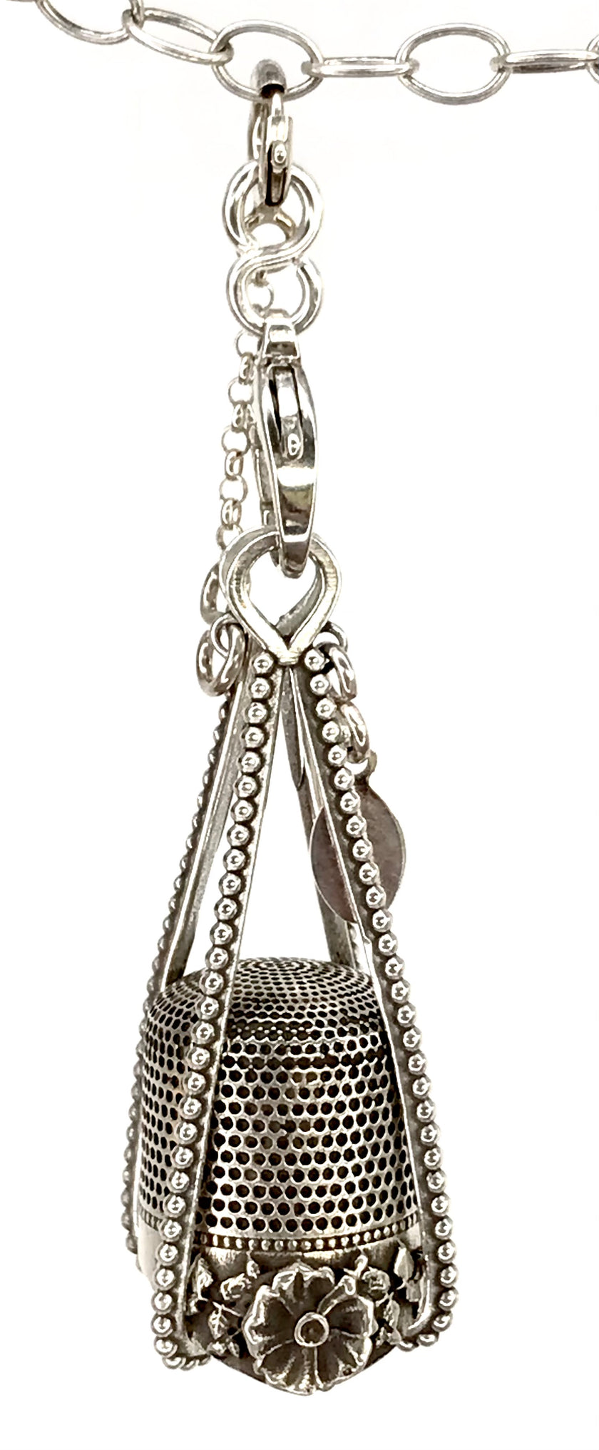 Wire Cages for Thimbles featuring an intricate sterling silver design for thimble storage and protection.