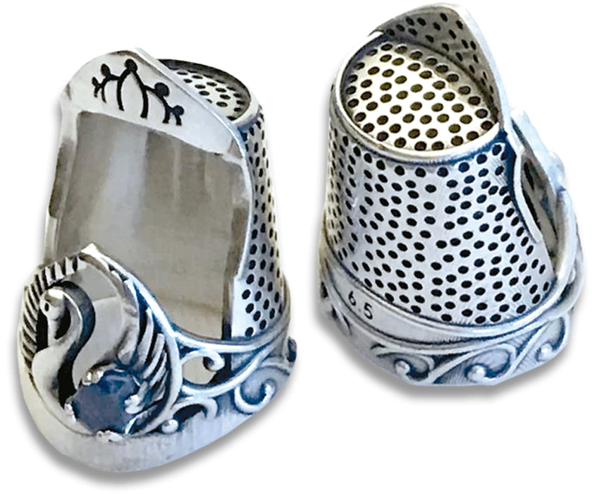 Swan Thimble made of high-quality sterling silver with unique pear-shaped gem and quilted rim for sewing.