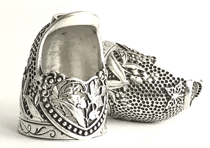 Lily of the Valley Tall Quilting Thimble in sterling silver, showcasing intricate floral designs and ergonomic shape for sewers.